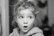© Iftikhar alam - Young girl showing surprise in indoor setting, with soft light highlighting her features, capturing a moment of wonder and joy during a playful afternoon