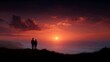 © Thares2020 - A couple silhouetted on a hill admiring a vibrant fiery sunset over the ocean