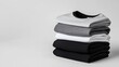 © Five Million Stock - Stacking pile of folded blank black, grey, gray, and white t-shirts with a round neck and a white background cutout. A mockup template for graphic design artwork,