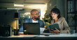 © Wess/peopleimages.com - Tech, team and business people in office for report, collaboration and feedback. Laptop, tablet proposal and research with discussion for proofreading, review and editing publication at night