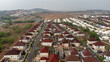 © AmazingAerialAgency - Aerial view of neat rows of houses with terracotta roofs create a warm contrast against the pale streets, Essan, Niger, Nigeria.