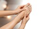 © Iuliia - Woman massaging her aching foot. Self care and health concept. Relaxation and pain relief for tired feet. Copy space background