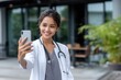 © Mongkol - Young female doctor and nurse live talk on anti-aging in modern asia sharing viral mental health content via mobile app selfie video