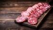 © Akanei - calabrese. Traditional Calabrese salami slices on a rustic wooden board with soft window light. menu design, packaging mockups, designed for food delivery and cloud-kitchen brand materials.