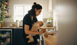 © Jacob Lund - Mother caring for baby in kitchen