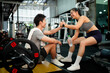 © Stella 16 - Asian woman and man sit in fitness gym with relax activity also look happiness after training and practice in fitness gym