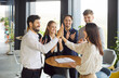 © Studio Romantic - Happy office group high five, team of professionals deal, business people in modern boardroom, discussing project, planning new contract terms and conditions, solve and share business ideas together