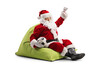 © Ljupco Smokovski - Santa Claus sitting on a bean bag with a football and and cheering