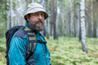 © metelevan - A man with a beard and a hat is standing in a forest