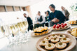 © deagreez - Business gathering featuring diverse team members enjoying refreshments during a collaborative meeting session