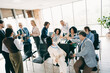 © deagreez - Coworkers celebrating success during a corporate meeting in an office space, showcasing teamwork and collaboration