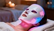 © soysuwan123 - A woman relaxes with a glowing LED facial mask, showcasing modern skincare technology in a serene spa environment.