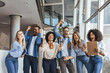 © Dragana Gordic - Diverse Group Of Friends Celebrating In Office Lobby With Raised Fists And Joy Together Today