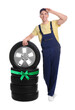 © New Africa - Tire service worker, car wheel and tires on white background. Special offer or discount