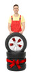© New Africa - Tire service worker, car wheel and tires on white background. Special offer or discount