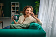 © Miljan Živković - Mature woman relaxing at home talking on phone