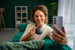 © Miljan Živković - Mature woman enjoying coffee while making a video call