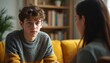 © Maryna - Teen boy confides in female therapist during session. Youngster discusses personal issues like school stress and mental health with professional. Safe space for adolescent communication and support.