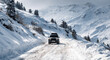 © Vinogradova - SUV driving through snowy mountain road, winter offroad adventure concept.