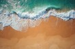 © Maryna - Ocean waves crash on a golden sand beach, seen from above. Turquoise water meets the shore, creating white foam patterns. Ideal for summer travel, nature, or relaxation themes.