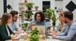 © ViskBx - Diverse group of professionals collaborate around a table with laptops in a modern office space
