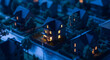 © THIBNH - Closeup of miniature house glowing in dark blue ambient lighting peaceful mysterious neighborhood sc 74853325 1