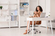 © Pixel-Shot - Beautiful young African-American businesswoman with cup of hot coffee and modern laptop at table in office