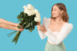 © Pixel-Shot - Beautiful young woman receiving bouquet of white roses on blue background
