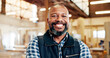 © P2000/peopleimages.com - Happy, black man and portrait with woodwork for carpenter or furniture business in workshop. Male person, artisan or timber craft with smile for wood repair, manufacturing or lumber production