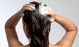 luxury beauty haircare advertisement, back view of an American woman washing her hair, extremely rich and dense shampoo foam covering wet dark hair