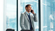 © FlexOn/peopleimages.com - Phone call, smile and thinking with business man in glass office for financial feedback or update. Conversation, finance and idea with happy employee in workplace for accounting or risk management