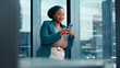 © FlexOn/peopleimages.com - Business, phone and text message with black woman in glass office for financial feedback or update. App, finance and typing with happy African employee in workplace for accounting or risk management