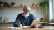 © Vadym - Senior man concentrates on tablet reviewing financial documents at kitchen table. He uses calculator, pen to analyze expenses, budget. Scene depicts retirement planning, personal finance management.