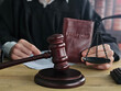 © Nadzeya - Courtroom scene featuring a judge with a gavel and a passport on the table highlighting legal responsibilities