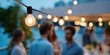 © Iryna - Outdoor evening gathering with string lights and diverse adults socializing