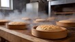 © Thares2020 - Rustic bakery with round bread loaves steaming and rising in wooden molds