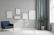 © Vadym - Minimalist living room with blue armchair and grey curtains. Several empty picture frames on wall. Plant in pot near window. Light grey wall.
