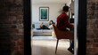© Westend61 - Couple relaxing at home with one person working on a computer and the other on a sofa