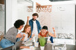 © Westend61 - Team celebrating business success together in a modern office