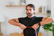 © Westend61 - Focused individual performing resistance band exercise at home