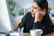 © Westend61 - Entrepreneur woman looking bored at her office desk with a computer and coffee cup