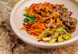 © AntAlexStudio - Colorful Asian noodle dish with vegetables and chicken served in a bowl
