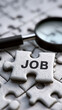 © Irina - The word 'WORK' with a puzzle and magnifying glass. A puzzle with the concept of job searching. A puzzle piece and magnifying glass with the word 'WORK.'