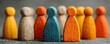 © Georgii - Colorful row of wooden toy figures in varied hues, representing unity and diversity