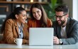 © Penelope - Happy multiethnic business team looking at laptop screen, celebrating success. High quality
