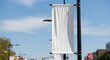 © RENA - Blank White Vertical Street Banner Mockup on City Lamppost Against Bright Blue Sky Clean Advertising Template