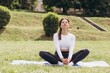 © anatoliycherkas - Woman meditating yoga pose outdoors in park