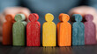 © Abu - Businessman covering wooden human figures representing commitment to employee protection and rights