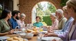 © Tanakorn - Happy multi-generational family enjoys a delightful outdoor meal together on a sunny brick patio, sharing joy and connection