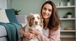 © Tanakorn - Young woman genuinely smiles, gently cuddling her loyal Australian Shepherd companion, creating a heartwarming scene of shared happiness within their cozy home